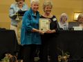 peggy receiving the gcg garden club trophy from gcg president peggy tucker